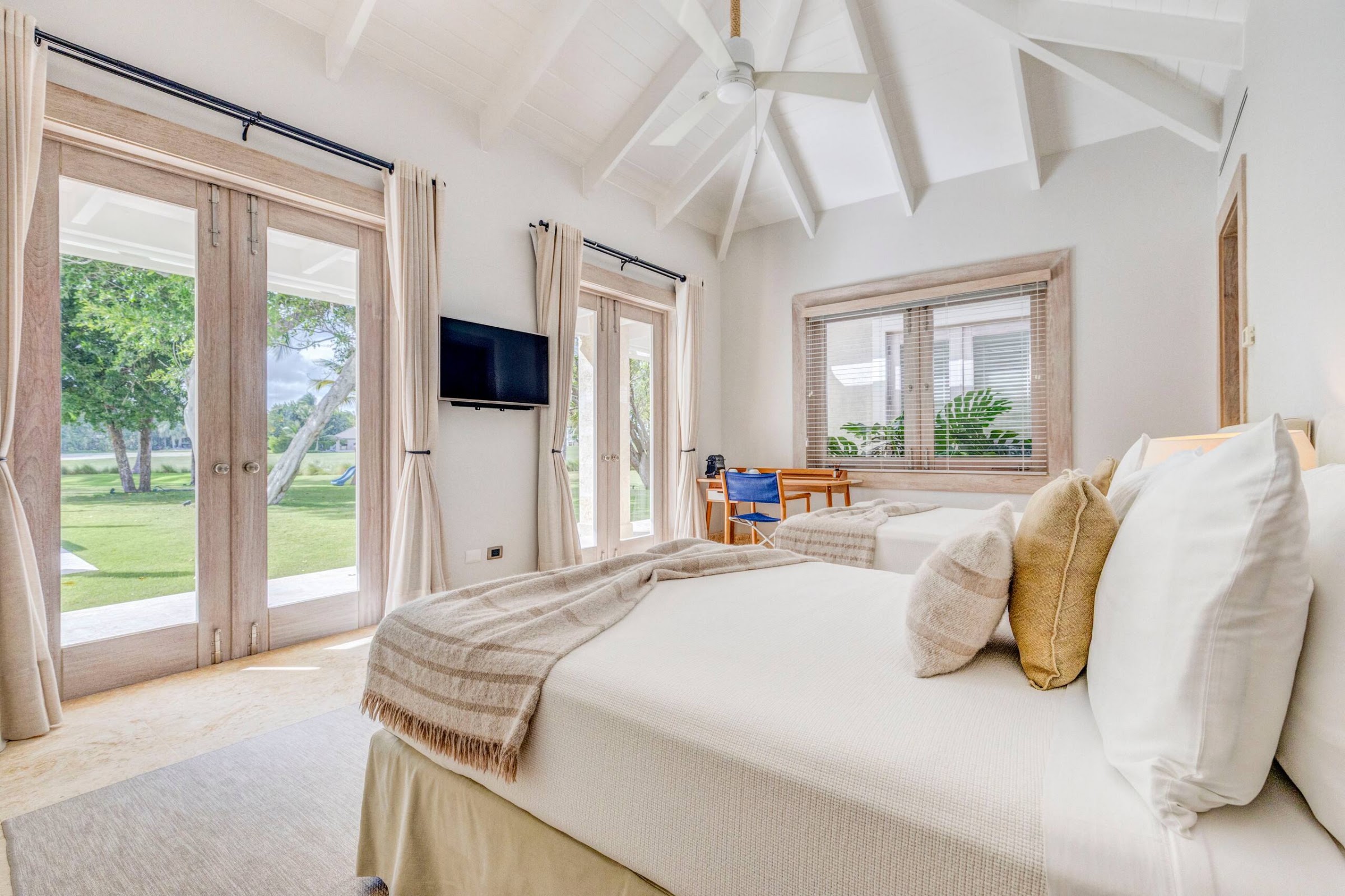 Bedroom with vaulted ceiling and garden view